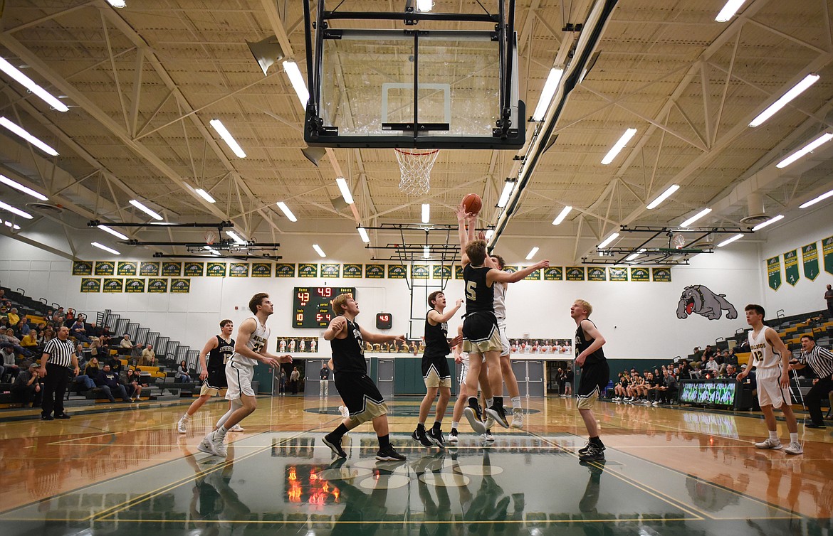 Talon Holmquist puts up the game-winning shot during Friday’s home battle against Stevensville. (Daniel McKay/Whitefish Pilot)