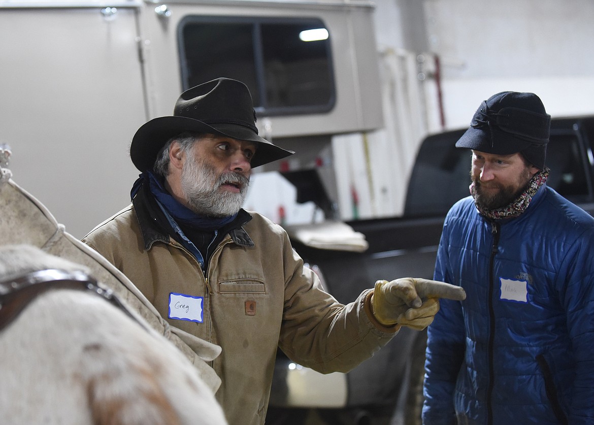 Greg Schatz, an experienced packer and horseman, gives Bigfork resident Mark Mercel some pointers on packing at last Saturday’s Back Country Horsemen of the Flathead’s clinic on safety and horse and mule packing. (Scott Shindledecker/Daily Inter Lake)