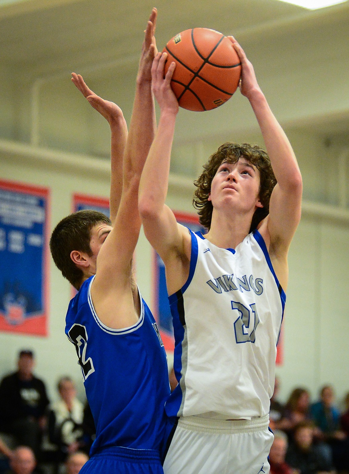 Bigfork’s Isak Epperly (21) goes to the basket against St. Ignatius’ Ross McPherson (12) at Bigfork High School on Thursday. (Casey Kreider/Daily Inter Lake)