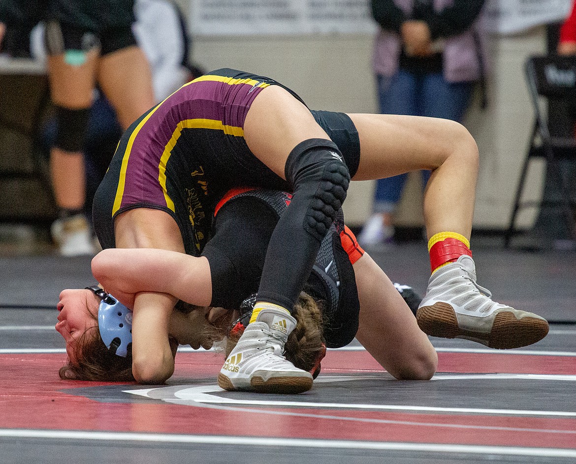 Bianca Johnson fights to avoid the pin in her match at the Huskie Invitational earlier this season.