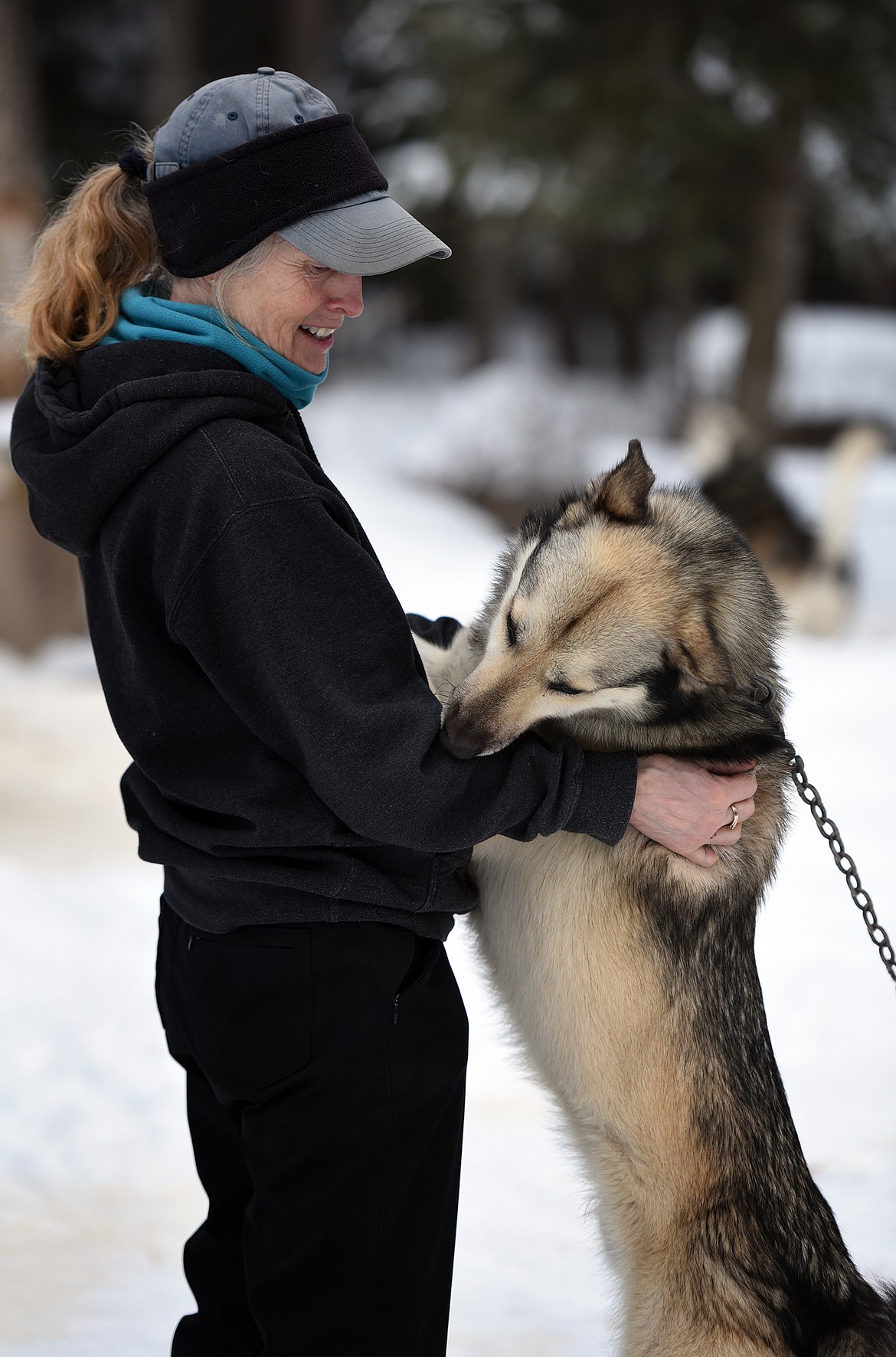 Sara Parr is greeted by Crockett, one of the 26 sled dogs owned by Parr and her husband, Butch.