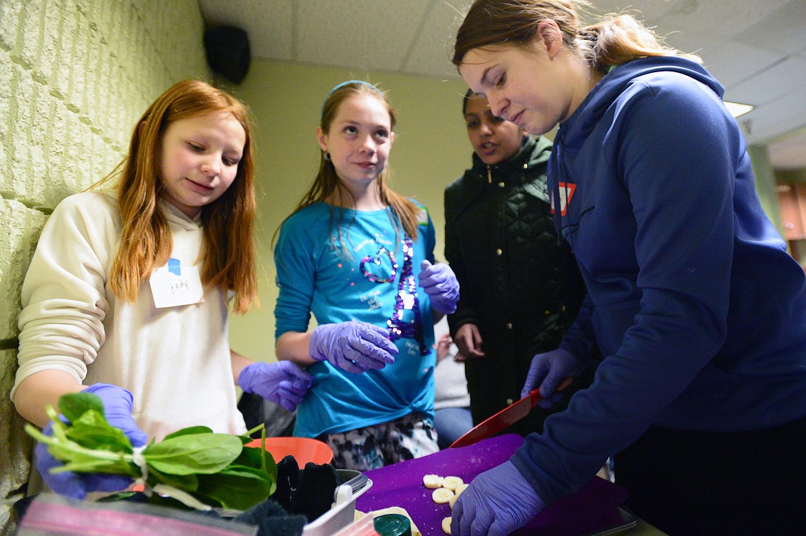 From left, Judith Young, Rita Sharbono, Tanisi Patel and Samantha Young work on their dish during an ImagineIF Chopped event, part of the library's Teen Maker Social program, at ImagineIF Library Kalispell on Thursday. (Casey Kreider/Daily Inter Lake)