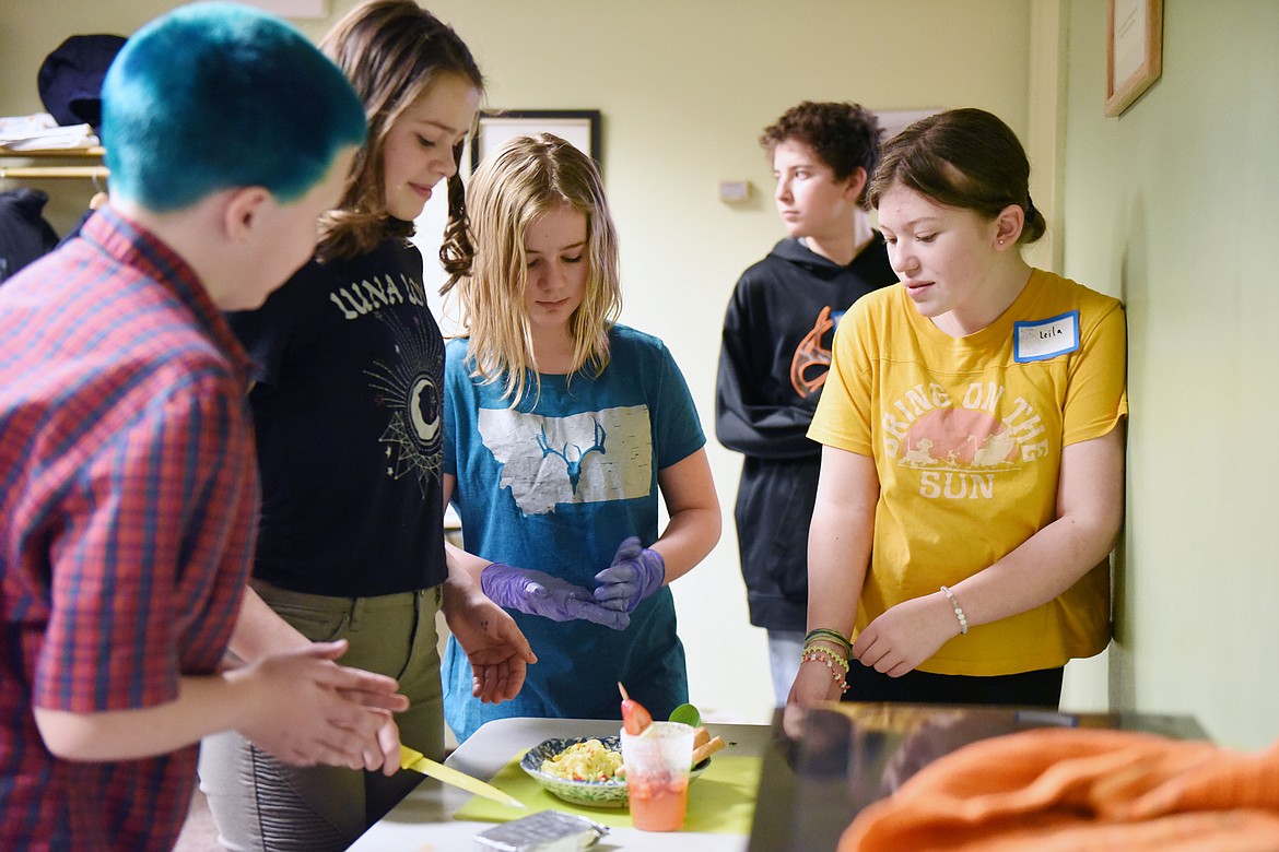 From left, Miles Dodge, Nevaeh Bowen, Marin Colley, Cayden Mahan and Leila McGillivray put some finishing touches on their dish during an ImagineIF Chopped event, part of the library's Teen Maker Social program, at ImagineIF Library Kalispell on Thursday. (Casey Kreider/Daily Inter Lake)