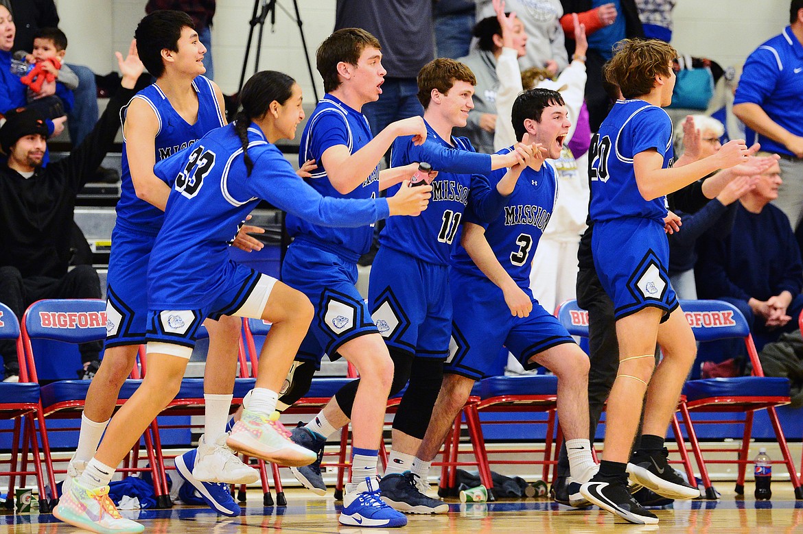 The Mission bench celebrates as time expires during their 47-44 win over Bigfork at Bigfork High School on Thursday. (Casey Kreider/Daily Inter Lake)