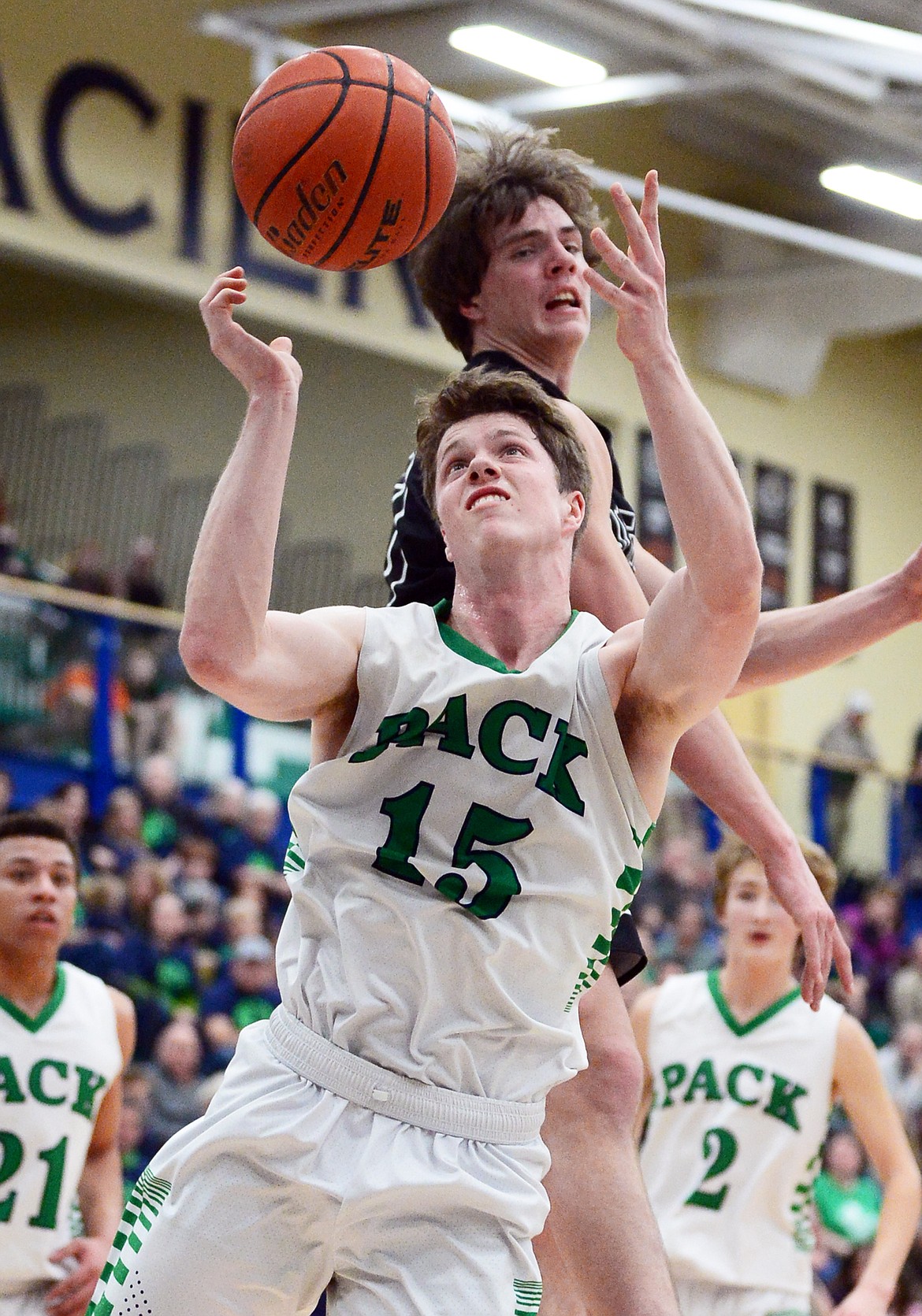 Glacier's Drew Engellant (15) grabs a rebound over Flathead's Cooper Smith (20) during a crosstown matchup at Glacier High School on Friday. (Casey Kreider/Daily Inter Lake)