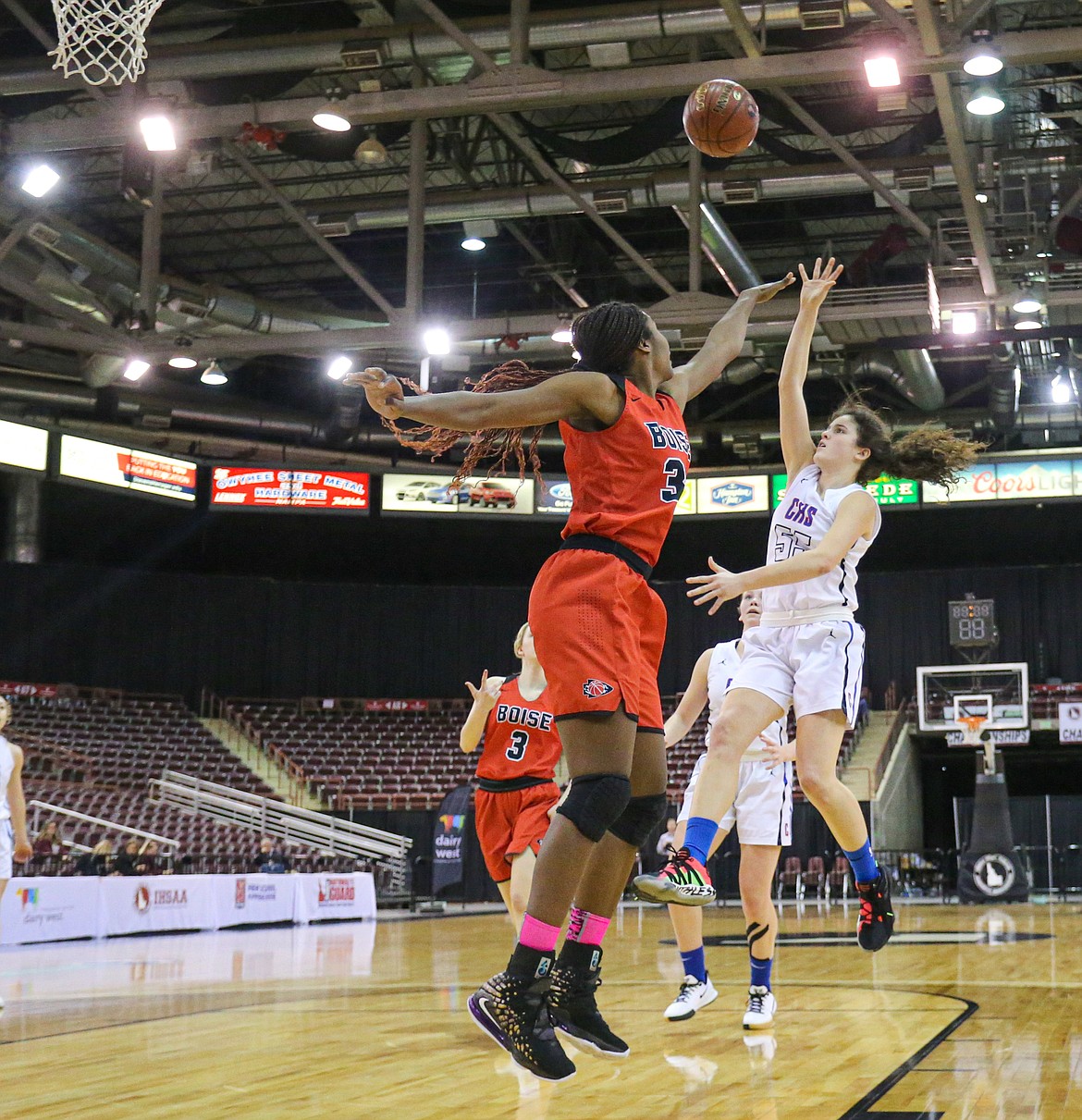 Skylar Burke (55) of Coeur d’Alene shoots over Peyton McFarland of Boise, a Utah signee, in a state 5A girls consolation game Friday at the Ford Idaho Center in Nampa.