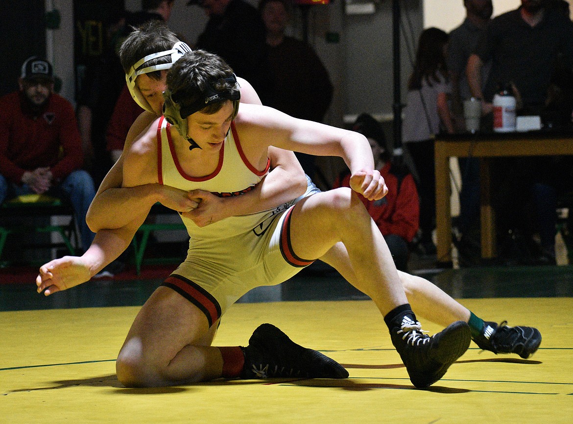 Sandpoint’s Jordan Birkhimer tries to escape from the grasp of Lakeland’s Callum Mickey during the 4A 120-pound regional championship Saturday at Lakeland.