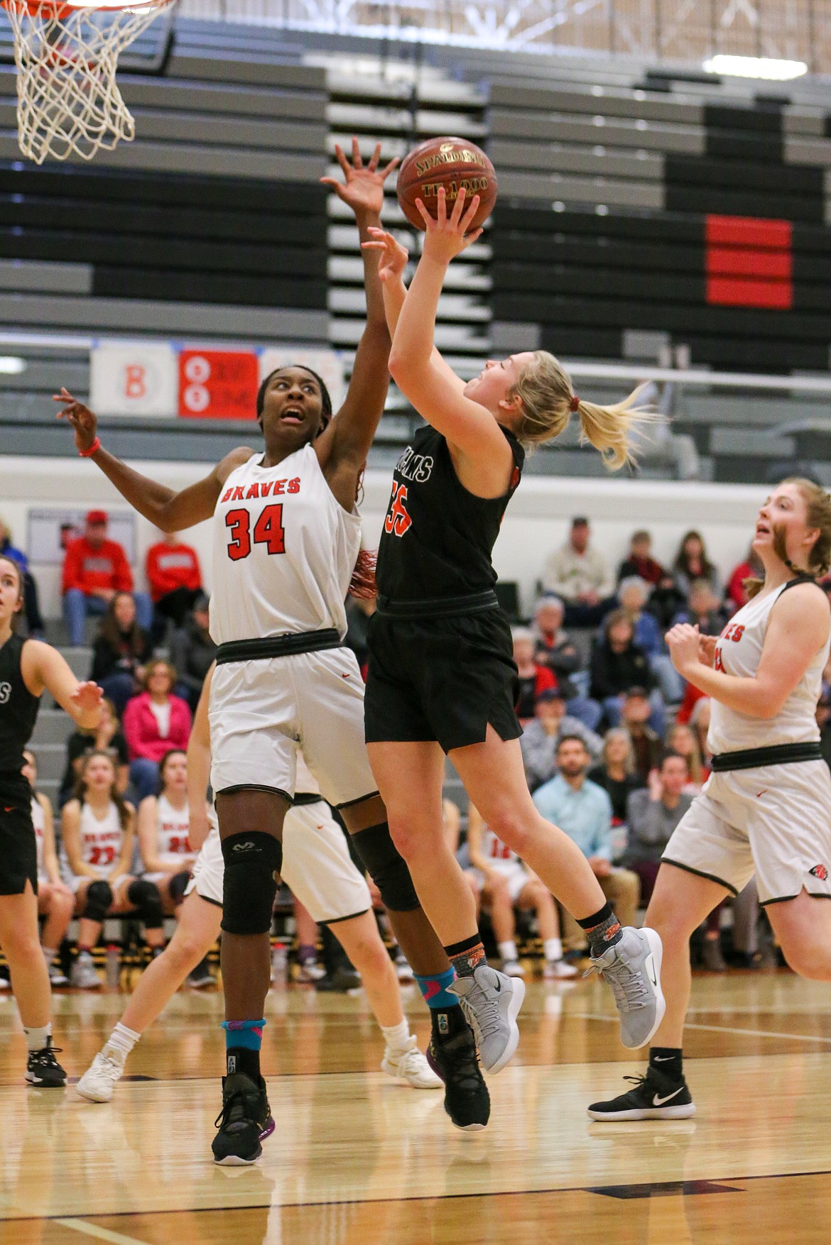 Photo by JASON DUCHOW PHOTOGRAPHY 
 Ali Carpenter, left, of Post Falls, shoots as Peyton McFarland of Boise defends in the state 5A girls consolation championship game Saturday morning at Ridgevue Hi