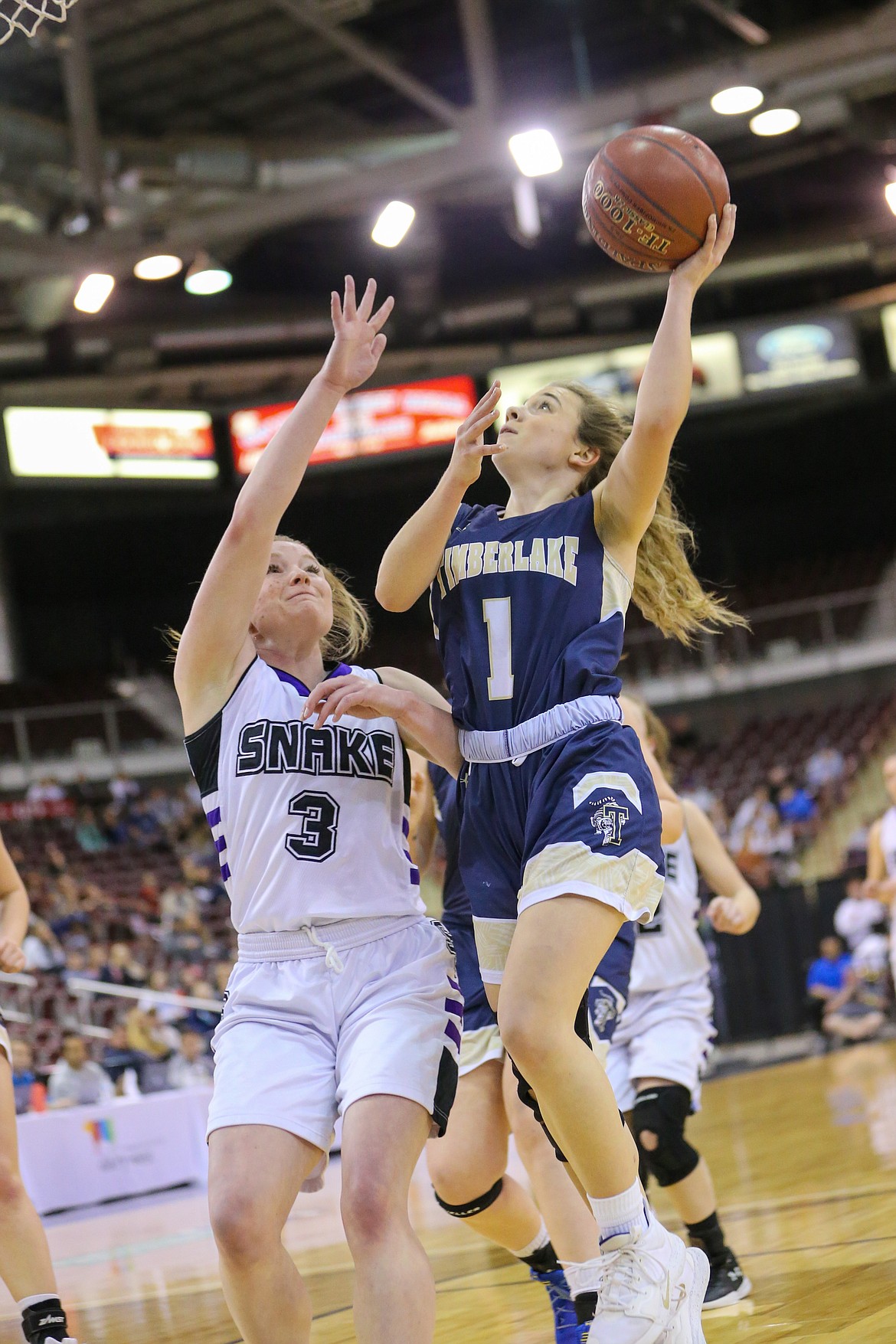 Photo by JASON DUCHOW PHOTOGRAPHY 
 Taryn Soumas (1) of Timberlake drives to the basket as Olivia Kracl of Snake River defends in the state 3A girls championship game Saturday at the Ford Idaho Cente