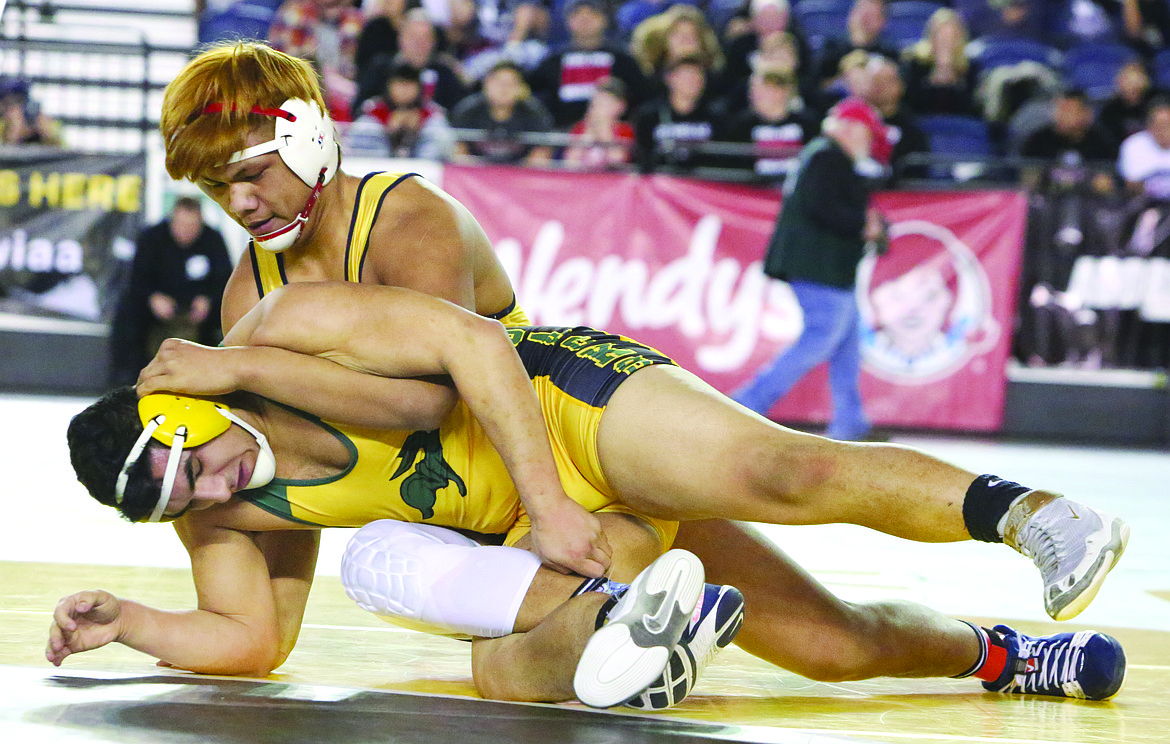 Connor Vanderweyst/Columbia Basin Herald 
 Quincy's Ruben Vargas (front) had his hands full with returning state champion Amadeo Flores-Pimentel of Selah in the 220-pound finals.