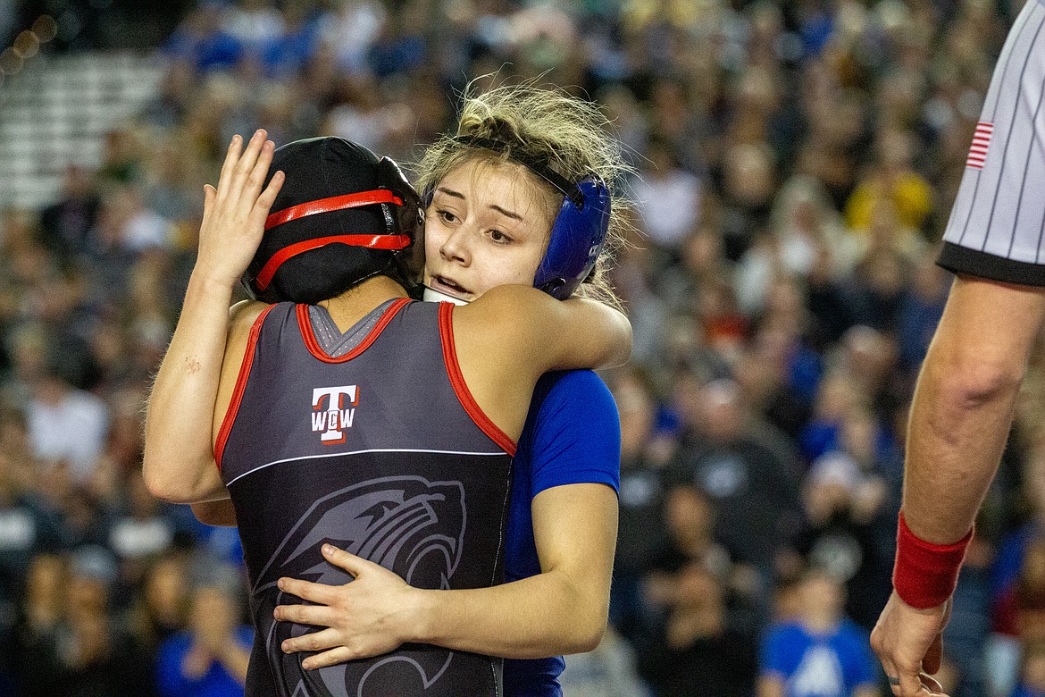 Casey McCarthy/Columbia Basin Herald Warden's Aaliyah Escamilla and Isabella Morales embrace after their final matchup on Saturday for the title at 105 at the Mat Classic.