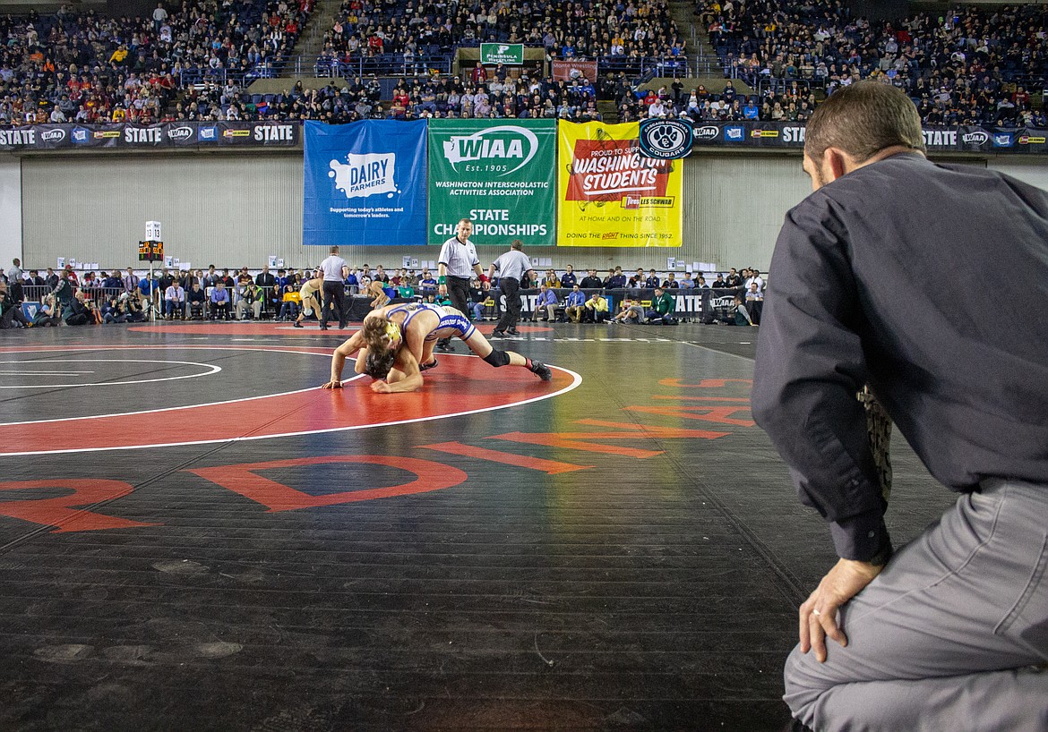 Casey McCarthy/Columbia Basin Herald Royal head coach Ben Orth watches his senior, Lorenzo Myrick, in the finals on Saturday in the Mat Classic.