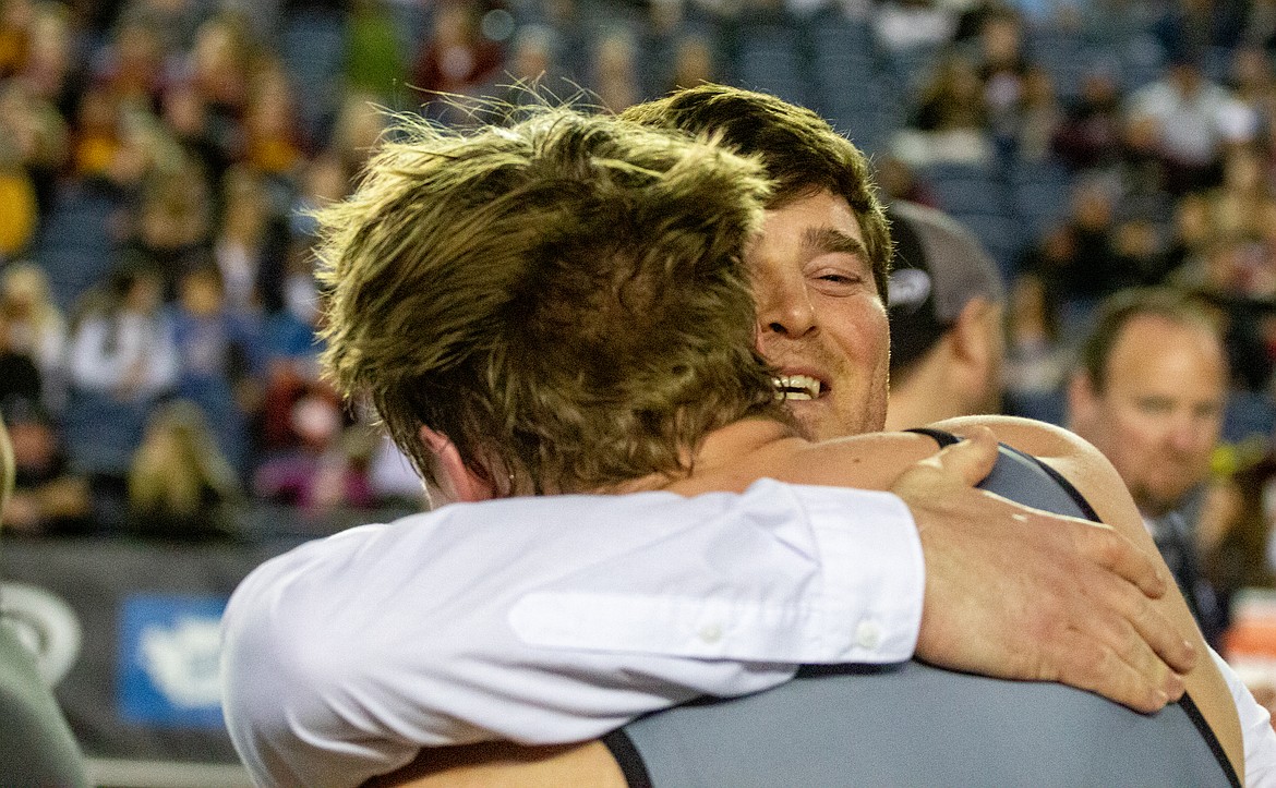 Casey McCarthy/Columbia Basin Herald Ephrata head coach Patrick Mitchell smiles as he hugs his senior and state champion, Mac Laird, after his match on Saturday in Tacoma.