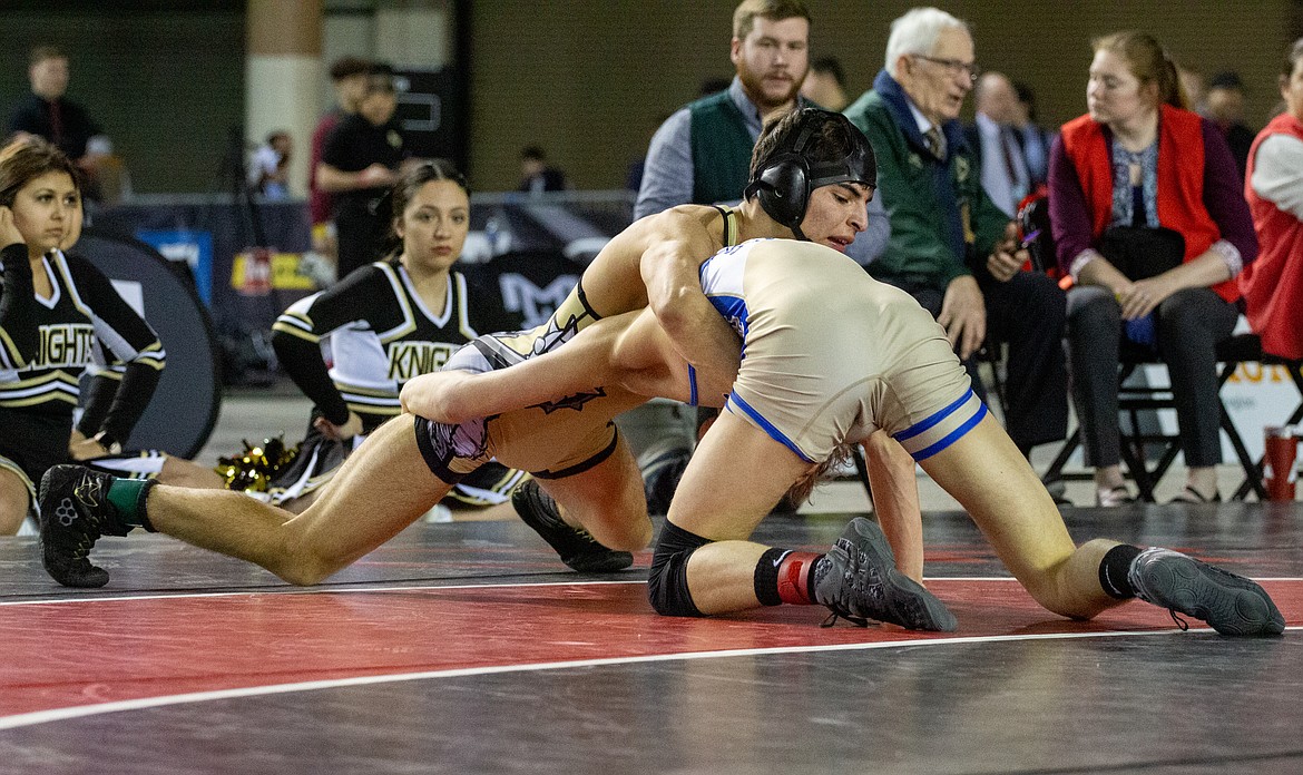 Casey McCarthy/Columbia Basin Herald Royal's Dominic Martinez works to overpower his opponent from Deer Park, Levi Miller, in the finals at 132 in 1A on Saturday.