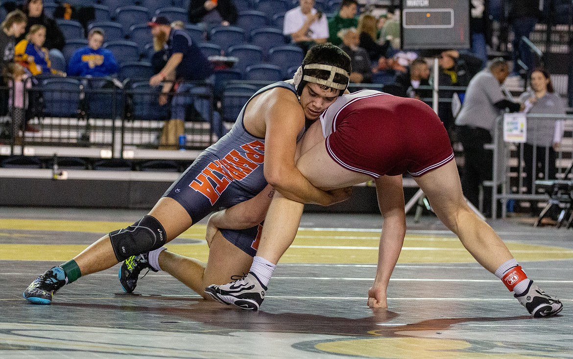 Casey McCarthy/Columbia Basin Herald Ephrata's Kevin Pelayo fights to take his opponent, Isaac Reavis, to the ground in the third-place match at 195 at the Mat Classic last weekend.