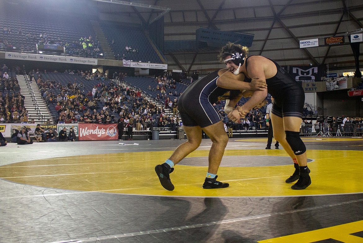 Casey McCarthy/Columbia Basin Herald Othello's Isaiah Perez looks to take down his friend and opponent Eduardo Mendez of Wapato as he moved toward claiming his third title at the Mat Classic on Satur