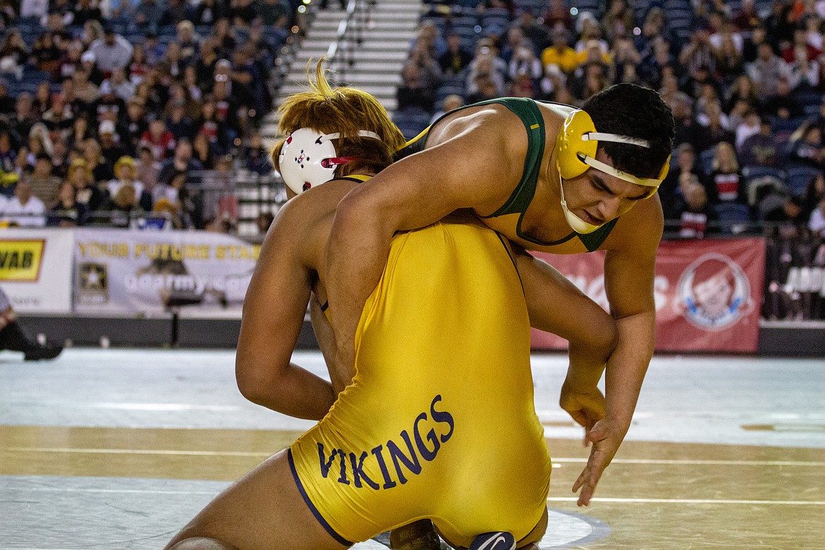 Casey McCarthy/Columbia Basin Herald Quincy's Ruben Vargas tries to keep up with Selah's Amadeo Flores-Pimentel in the championship round at 220 in 2A at the Mat Classic Saturday evening. Flores-Pime