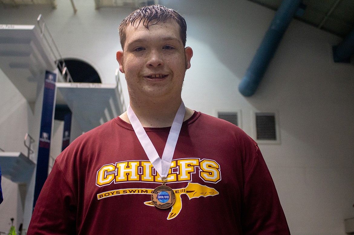 Casey McCarthy/Columbia Basin Herald Moses Lake senior Jared Grant poses with his first medal of the day after competing the finals of the unified 50-yard freestyle on Saturday at the 4A state finals