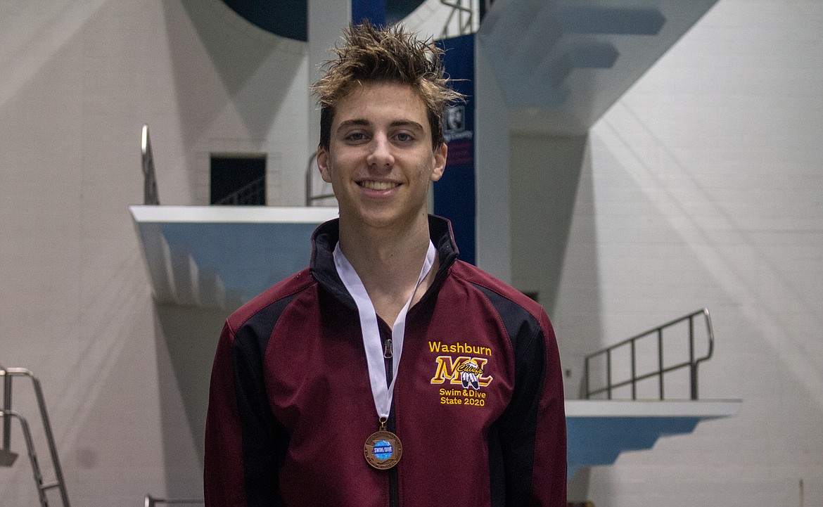 Casey McCarthy/Columbia Basin Herald Zachary Washburn poses with his first medal of the day after taking third place in the 50-yard freestyle, breaking the school record in the process.