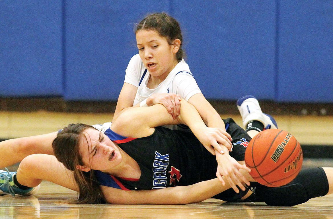 Mission’s Madyson Currie and Bigfork’s Emma Berreth scramble for the ball in first quarter. (Paul Sievers/The Western News)