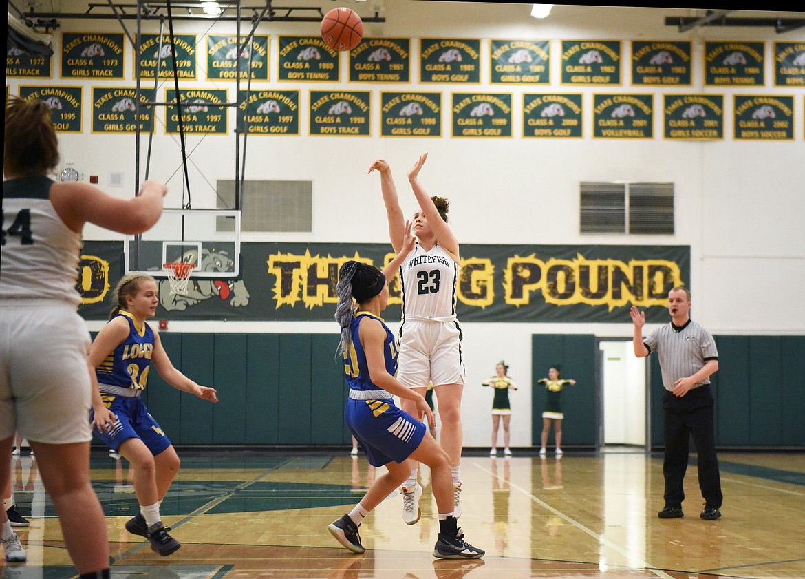 Gracie Smyley launches a three during Monday’s play-in victory over Libby. (Daniel McKay/Whitefish Pilot)