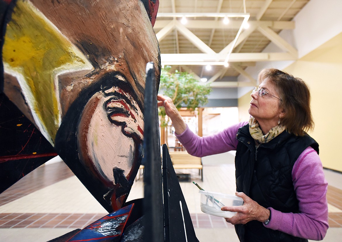 Artist Jennifer Thompson works on her piece titled “Aspects of the Broken Heart” at Gateway Community Center in Kalispell on Friday. (Casey Kreider/Daily Inter Lake)