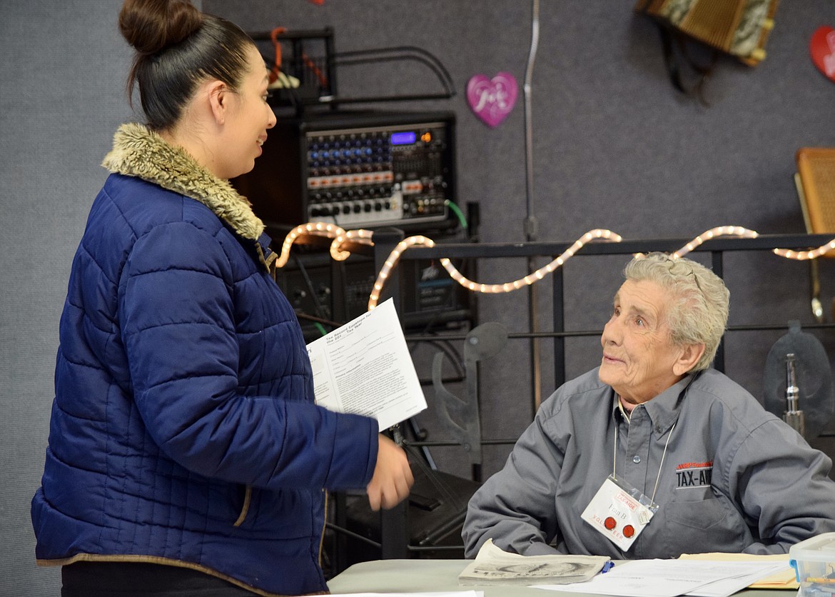 Longtime AARP Tax-Aide volunteer Fran Bill talks with a client who just had her taxes done at the Moses Lake Senior Center on Tuesday. Bill, 91, has been a volunteer tax preparer for 31 years.
