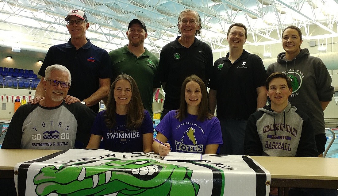 Post Falls High senior Micah Sharples recently signed a letter of intent to swim at NAIA College of Idaho in Caldwell. Seated from left are Brad Sharples-Faucher (father), Michelle Faucher-Sharples (mother), Micah Sharples and Charles Daniel Sharples (brother); and standing from left are coach Mike Hamm, Coeur d’Alene Area Swim Team coach Jade Sobek, CAST coach Bob Wood, CAST coach David Dolphay and Post Falls High School coach Jessica Watkins.