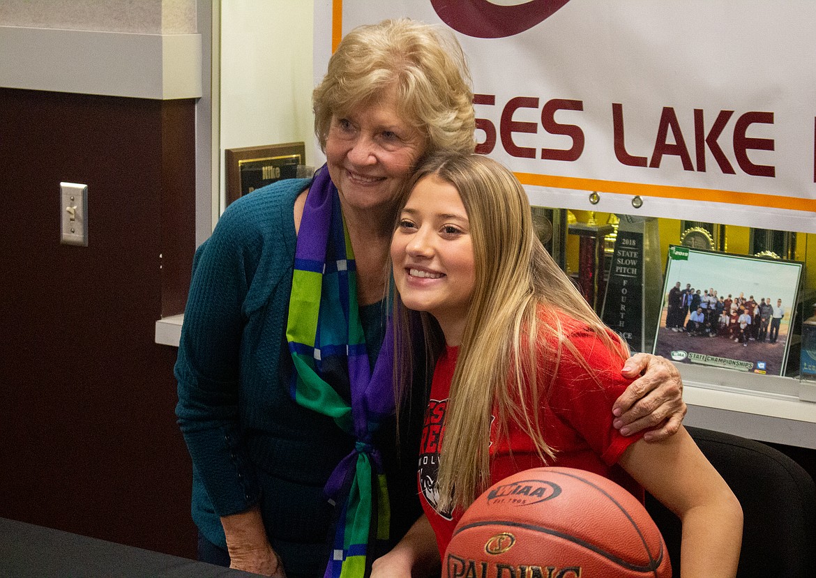 Casey McCarthy/Columbia Basin Herald Madisyn Clark smiles with her grandmother, Fay Ann McCourtie, at Moses Lake High School as she signs to continue her basketball career at Western Oregon Universit