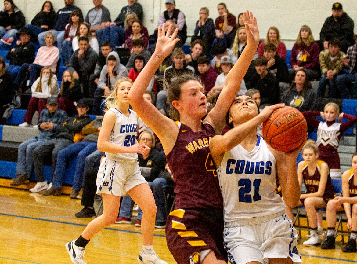 Casey McCarthy/Columbia Basin Herald Jlynn Rios drives in for the layup through the contact for Warden on Feb. 13 at Warden High School.