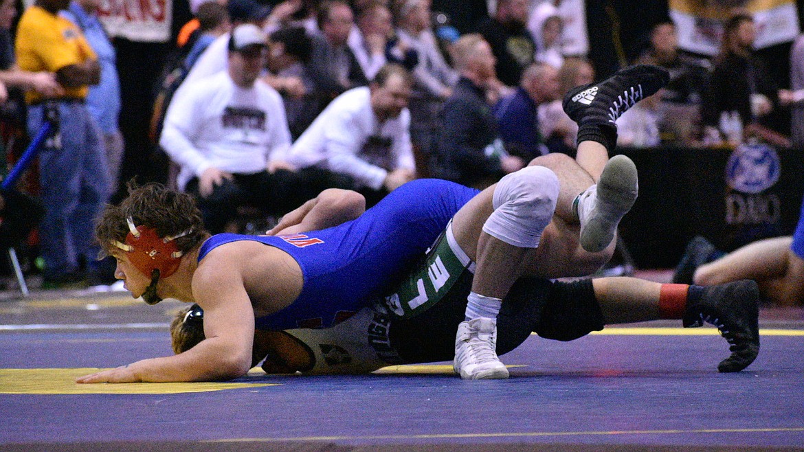 Nolan Randles of Coeur d’Alene looks to pin Tyson Jones of Eagle in their state 5A 152-pound quarterfinal match Friday at the Ford Idaho Center in Nampa. Randles won 13-8.