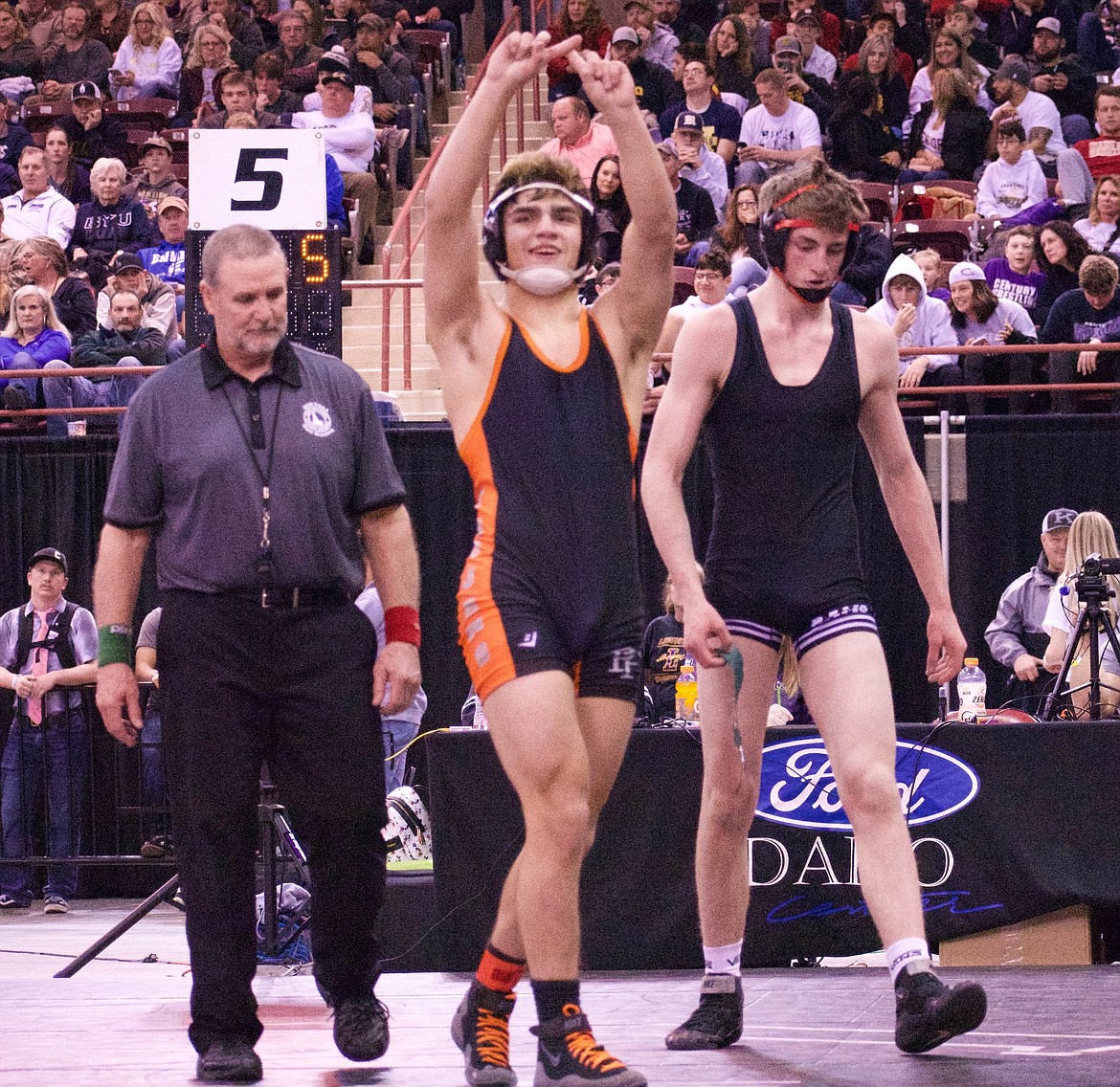 A.J. De La Rosa of Post Falls celebrates after beating Kael Cordingley of Highland to win the 5A 145-pound championship Saturday at the Ford Idaho Center in Nampa.