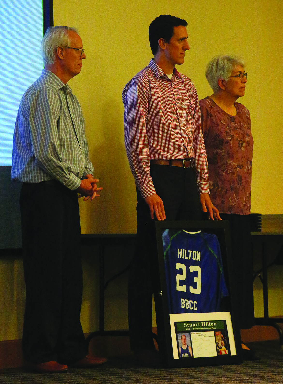 Connor Vanderweyst/Columbia Basin Herald 
 Former Big Bend basketball player Stuart Hilton, who passed away in 2016, was honored with a framed shooting shirt and commemorative message at the college’s Hall of Fame banquet. Stuart’s parents, Hugh and Nalene, and his brother Shaun accepted the shirt.