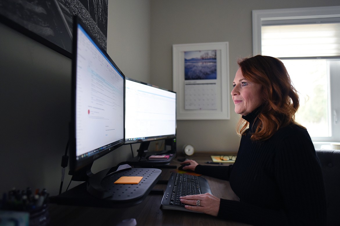 Deanna Beuth works in her office in her residence in Bigfork on Thursday, Feb. 27. (Casey Kreider/Daily Inter Lake)