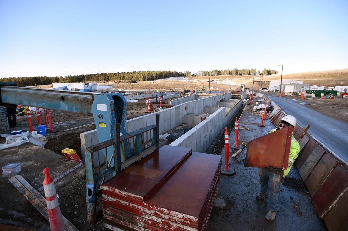 Kyle Quimby, with Swank Enterprises, stacks concrete forms alongside where a new scale house will be constructed at the entrance and exit to the county landfill on Tuesday, March 3. (Casey Kreider/Daily Inter Lake)
