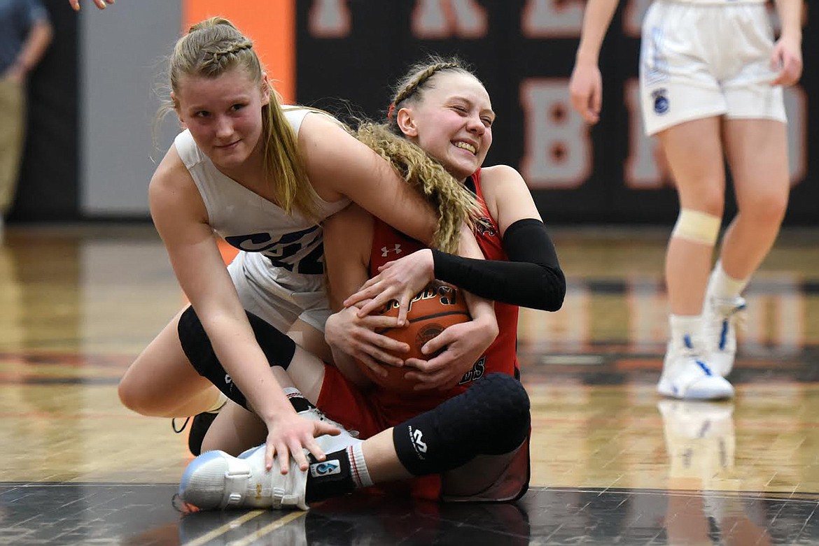 Clark Fork’s Zoe Kelsey battles with West Yellowstone’s Emmie Collins for a loose ball Friday. (Jeremy Weber/Mineral Independent)