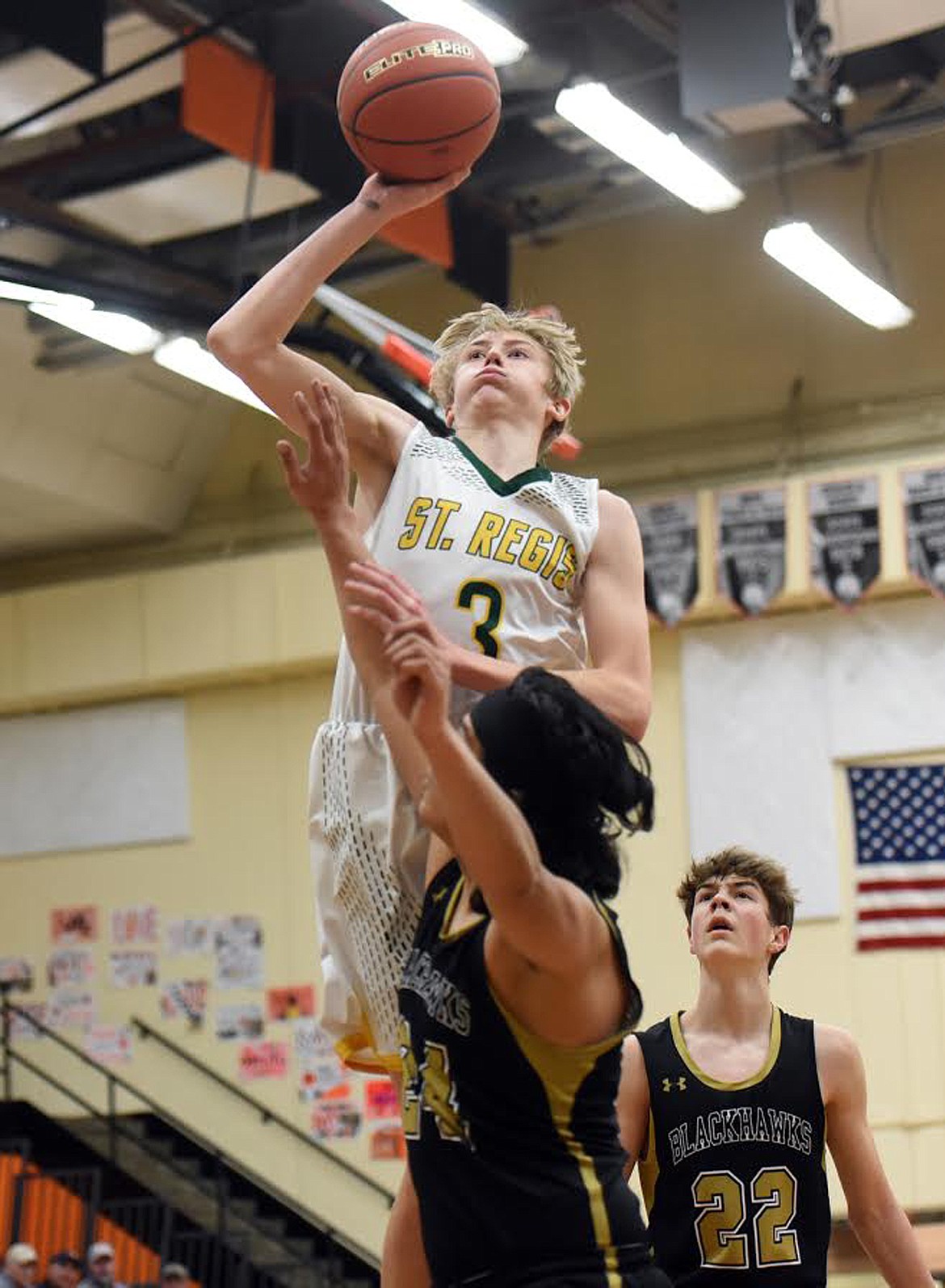 St. Regis forward Andrew Sanford goes up for a shot over Seeley-Swan’s Brayden Rodriguez at the Western C Divisional basketball tournament Friday. (Jeremy Weber/Mineral Independent)