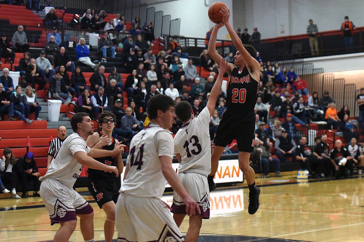 Ronan's Zarec Couture shoots over Butte Central players in the first round of the Western A Divisional Tournament Feb 27. Ronan fell to Butte Central 56-30. (Whitney England/Lake County Leader)