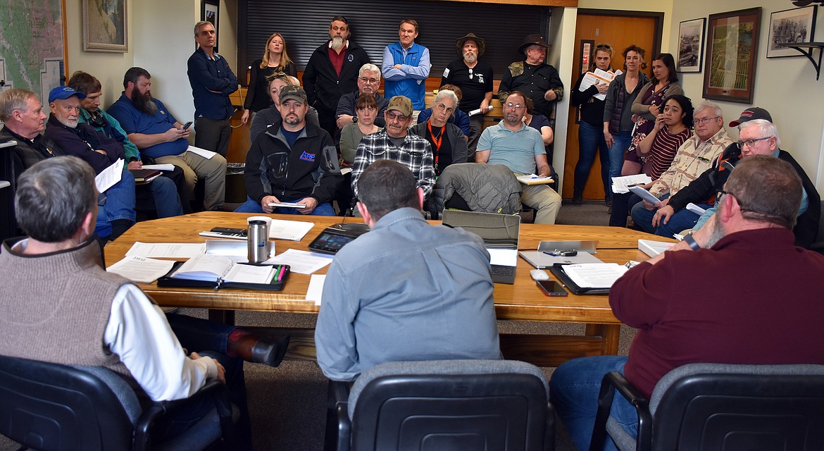 Lincoln County commissioners, from left, Jerry Bennett, Josh Letcher and Mark Peck meet with local and state officials to discuss the Montana Department of Environmental Quality’s plans for taking over the Libby Asbestos Superfund site before a packed audience March 4. (Duncan Adams/The Western News)