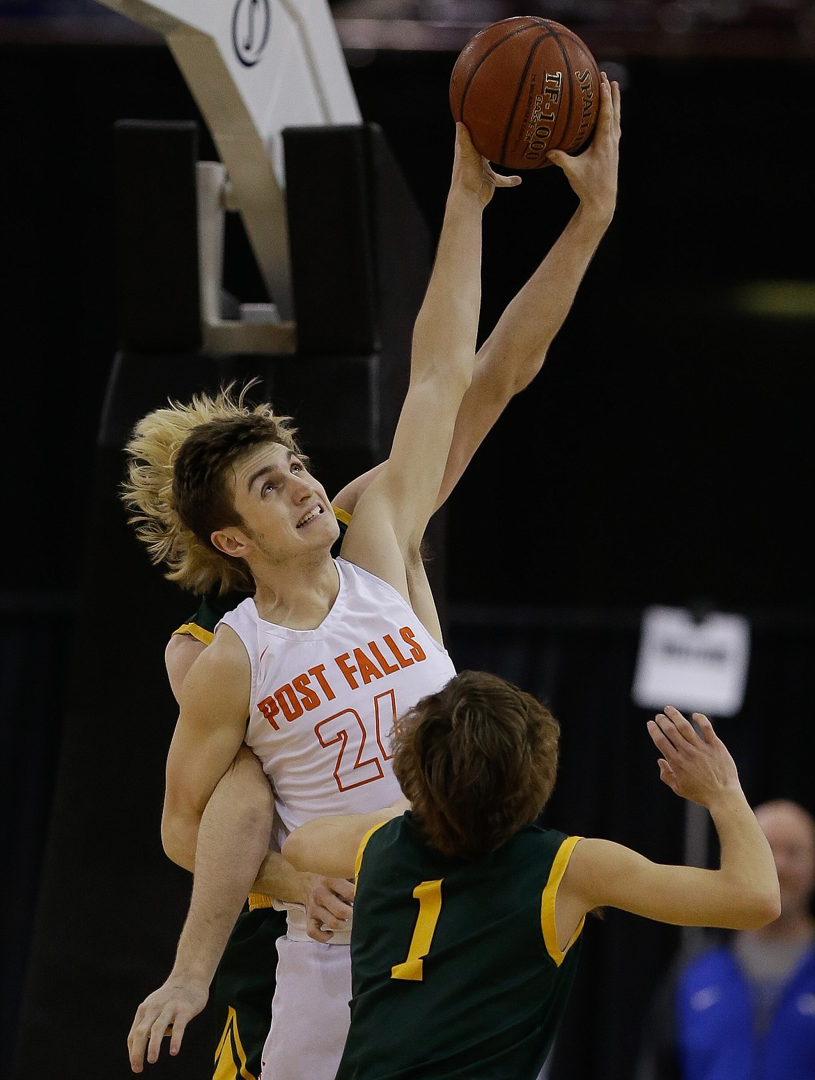 Post Falls wing Alex Horning (24) gets tied up with Borah’s Austin Bolt going for a rebound in the state 5A boys basketball championship game at the Ford Idaho Center in Nampa on Saturday.