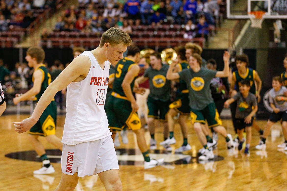 STEVE CONNER/Special to the Press
Post Falls’ Isaac Ballew (12) walks off the the court as Borah celebrates winning the state 5A boys basketball championship on Saturday night at the Ford Idaho Center in Nampa.