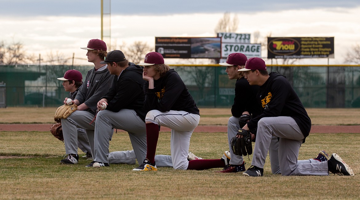 Casey McCarthy/Columbia Basin Herald Pitchers kneel beside the mound in practice on Tuesday at Larson Playfield as the Moses Lake baseball team gets set for the 2020 season