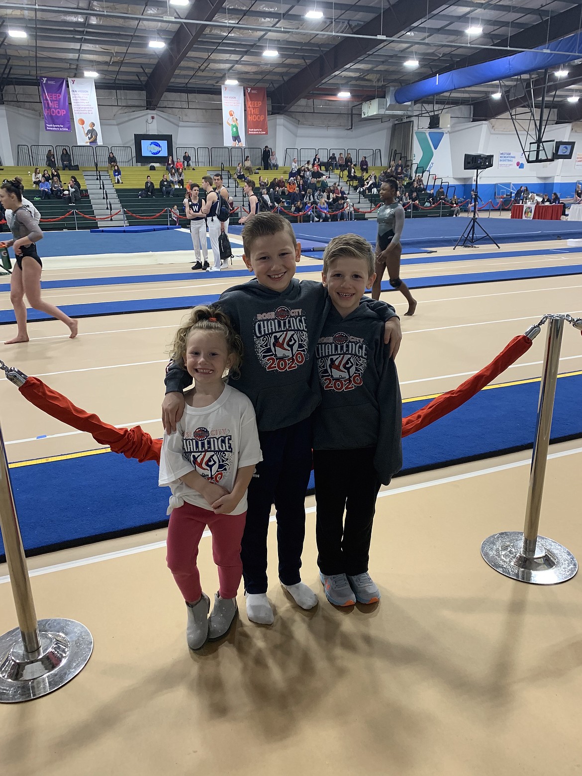 Courtesy photo 
 Team Avant Coeur Gymnastics Level 5 and 4 brothers and their biggest fan at the Rose City Challenge in Beaverton, Ore. From left are Paisley Moore, Brayson Moore and Rowen Moore.