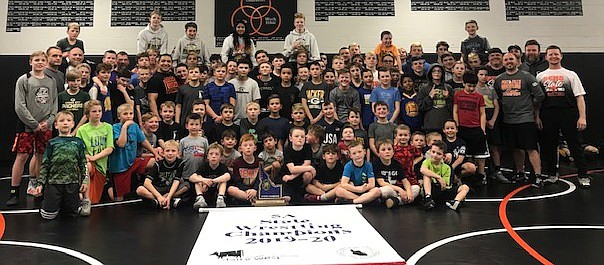 In what has become a tradition, the state 5A wrestling champion Post Falls Trojans presented the championship trophy and banner to the young wrestlers of Team Real Life at TRL practice on March 3. The Post Falls state team members pictured are Keanyn DeGroat; Connor McCarroll; Mando Laguna; Raji Singh; Isaac Jessen, 2nd; Isaiah Laguna, 3rd; Ryan Graves, 3rd; Braxton Mason, 4th; Ethan Miller, state champion; Roddy Romero, 2nd; Tyler Cook, 4th; A.J. De La Rosa, state champion; Lane Reardon, 2nd;  Zack Campbell, 6th;  Luke Martin and Avery McSpadden. Also part of the state team but not pictured are Logan Carrick, Tommy Hauser and Dominic Monti. For more information on Team Real Life wrestling, contact Lonnie at 208-660-8579.