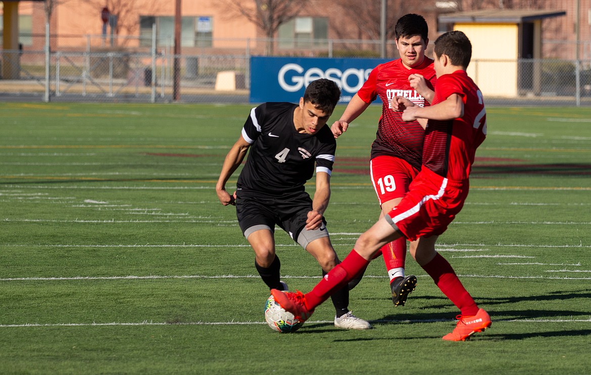 Casey McCarthy/Columbia Basin Herald Moses Lake senior Raymundo Curiel (black jersey) makes a move past a pair of Othello defenders at the jamboree at Lions Field on Wednesday. Curiel will look to lead the Chiefs in his final season on the pitch.