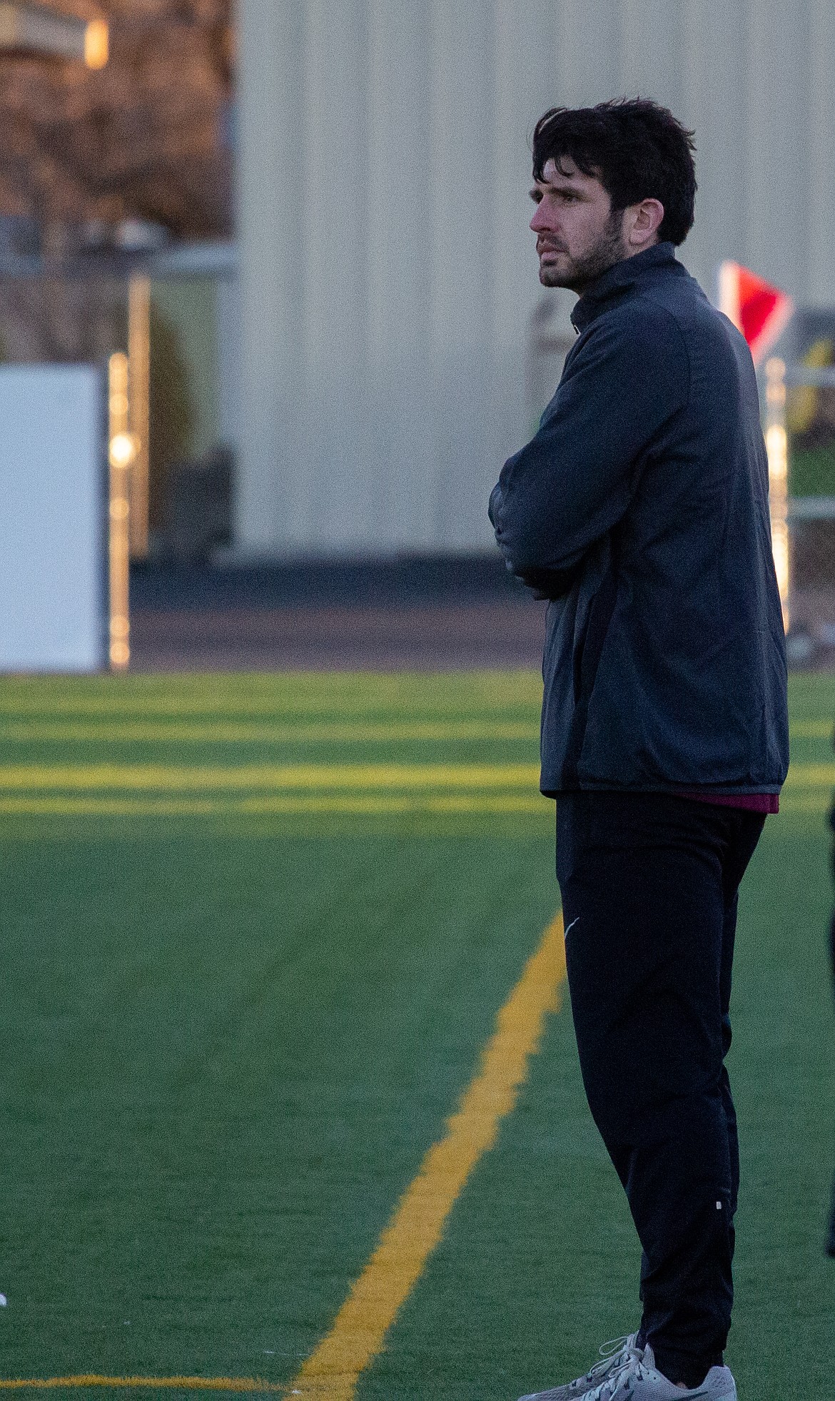 Casey McCarthy/Columbia Basin Herald First-year head coach Derrick Gonzales watches the Chiefs from the sidelines as Moses Lake gears up for another spring season at Lions Field.