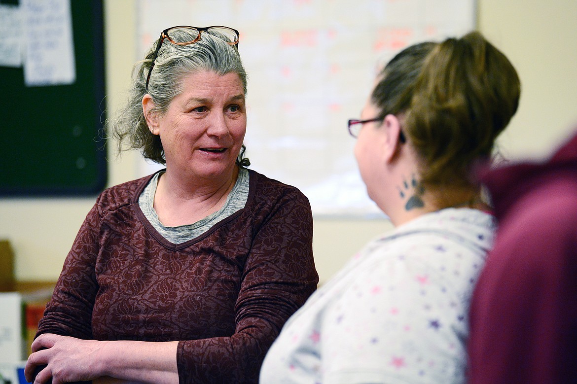 Pam Gerwe, left, head of the Columbia Falls special education “Able Table” program, speaks to a parent at the North Valley Food Bank on Wednesday, March 11. (Casey Kreider/Daily Inter Lake)