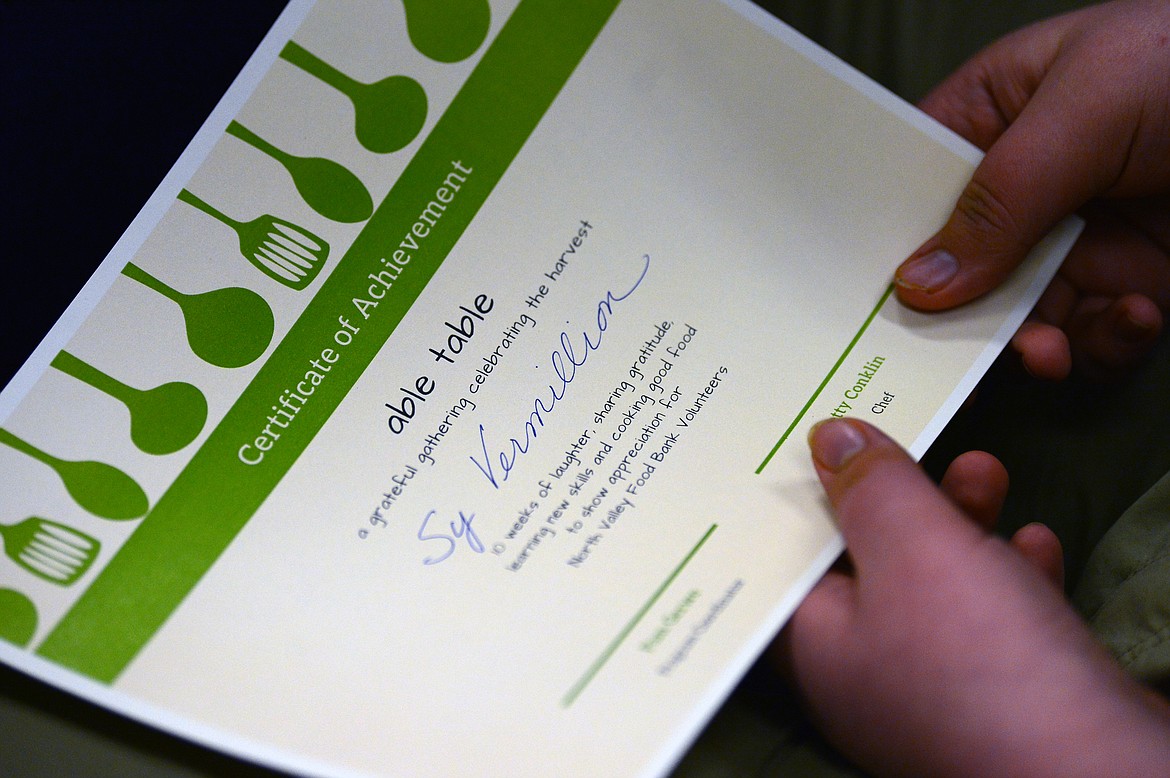 Columbia Falls student Sy Vermillion holds his “Able Table” certificate of achievement at North Valley Food Bank on Wednesday, March 11. (Casey Kreider/Daily Inter Lake)