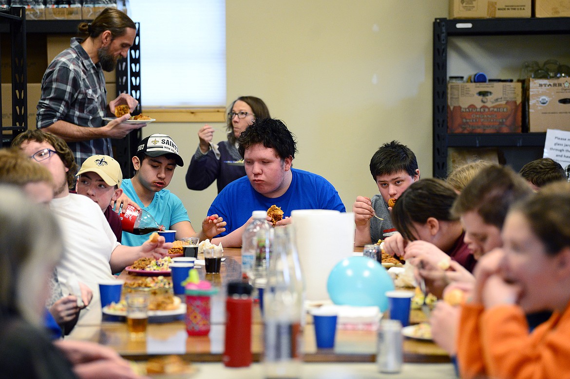 Columbia Falls students enjoy the meal they prepared for their “Able Table” program at the North Valley Food Bank on Wednesday, March 11. (Casey Kreider/Daily Inter Lake)