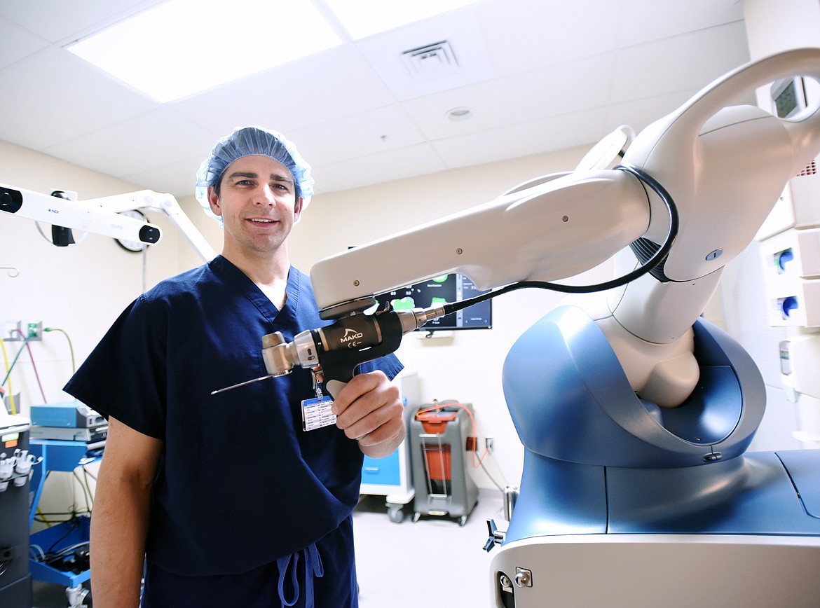 Dr. Timothy Joyce, an orthopedic surgeon with Northwest Orthopedics & Sports Medicine, stands with the Stryker Mako Robotic Arm at North Valley Hospital in Whitefish on Thursday. (Casey Kreider/Daily Inter Lake)